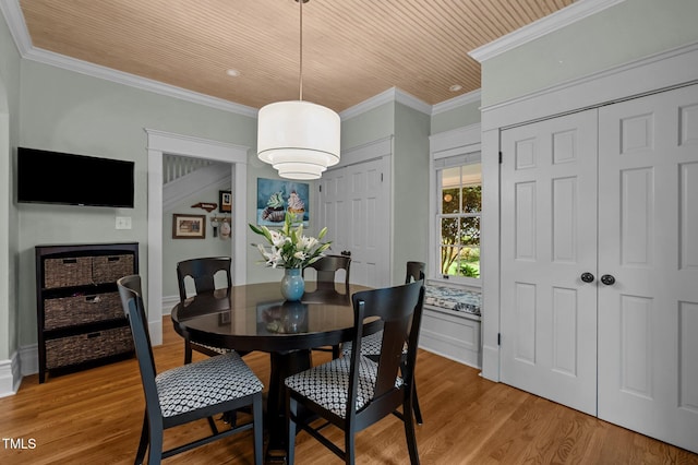 1015 Watts St, Durham, NC 27701 - dining room with light wood-style flooring, crown molding, wood ceiling, and baseboards