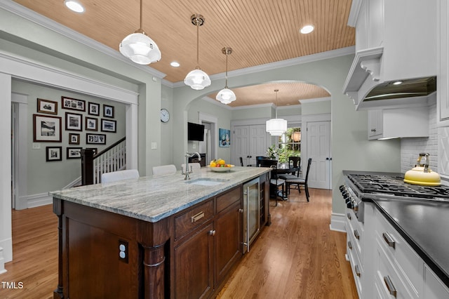 1015 Watts St, Durham, NC 27701 - kitchen featuring arched walkways, a sink, stainless steel gas stovetop, white cabinetry, and wood ceiling