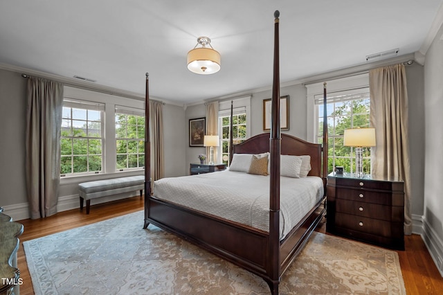 1015 Watts St, Durham, NC 27701 - bedroom with crown molding, wood finished floors, and baseboards