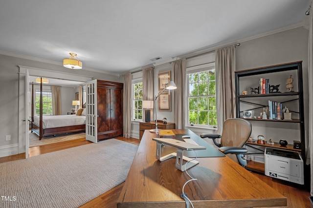 1015 Watts St, Durham, NC 27701 - home office with healthy amount of natural light, crown molding, wood finished floors, and baseboards