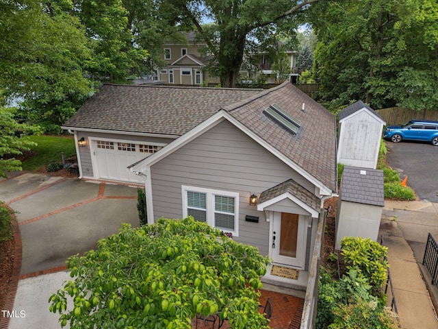 1015 Watts St, Durham, NC 27701 - view of front facade featuring driveway, roof with shingles, and fence