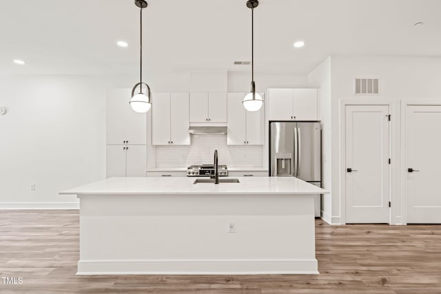 615 Daniels St Unit 215, Raleigh, NC 27605 - kitchen featuring stainless steel fridge with ice dispenser, under cabinet range hood, a sink, white cabinetry, and recessed lighting