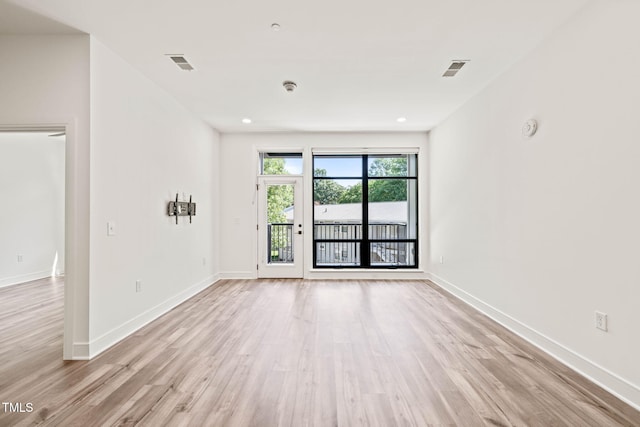 615 Daniels St Unit 215, Raleigh, NC 27605 - empty room with light wood-style floors, baseboards, a smoke detector, and recessed lighting