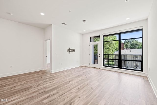 615 Daniels St Unit 215, Raleigh, NC 27605 - empty room with light wood finished floors, baseboards, and recessed lighting