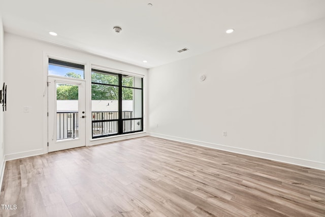 615 Daniels St Unit 215, Raleigh, NC 27605 - unfurnished room with light wood-type flooring, baseboards, recessed lighting, and a smoke detector