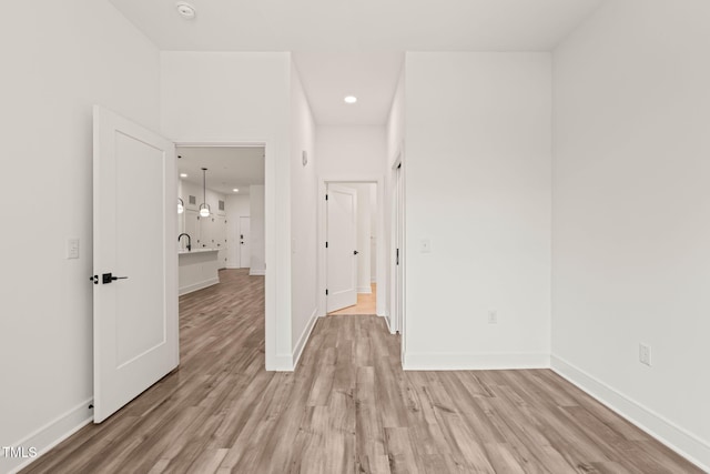 615 Daniels St Unit 215, Raleigh, NC 27605 - unfurnished bedroom with light wood-style floors, baseboards, and recessed lighting