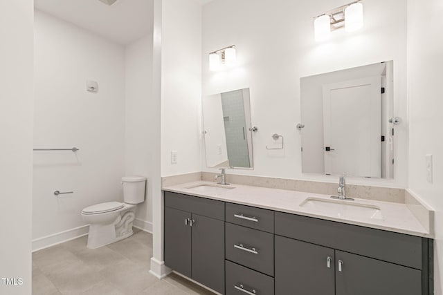 615 Daniels St Unit 215, Raleigh, NC 27605 - full bathroom featuring double vanity, toilet, and baseboards