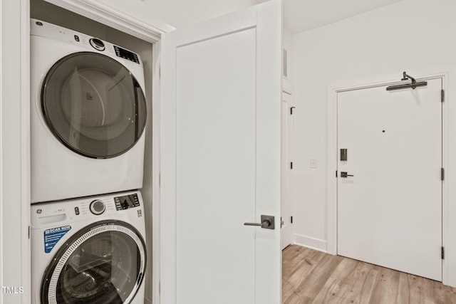 615 Daniels St Unit 215, Raleigh, NC 27605 - washroom with stacked washer and clothes dryer and light wood finished floors