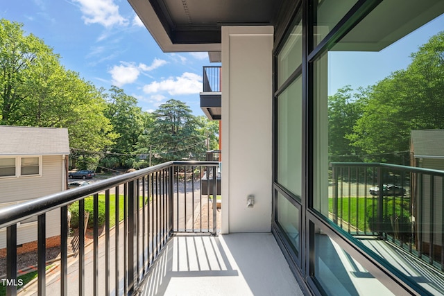 615 Daniels St Unit 215, Raleigh, NC 27605 - balcony featuring view of wooded area