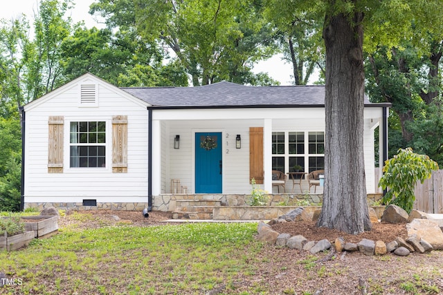 single story home with roof with shingles and a porch