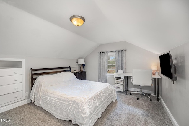 bedroom with carpet, vaulted ceiling, baseboards, and a desk