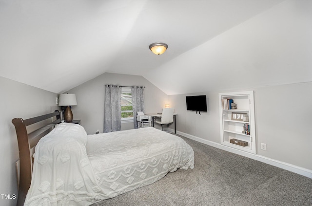 bedroom with carpet flooring, vaulted ceiling, and baseboards