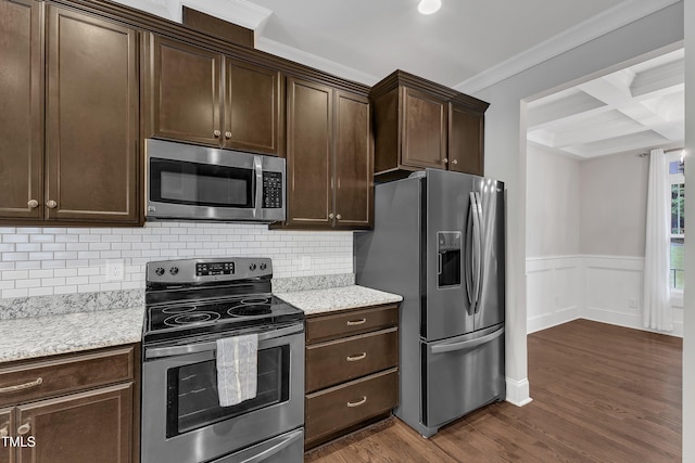 kitchen featuring stainless steel appliances, ornamental molding, dark brown cabinets, dark wood-style floors, and beam ceiling