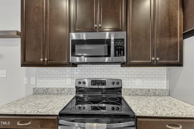 kitchen with appliances with stainless steel finishes, dark brown cabinets, and tasteful backsplash