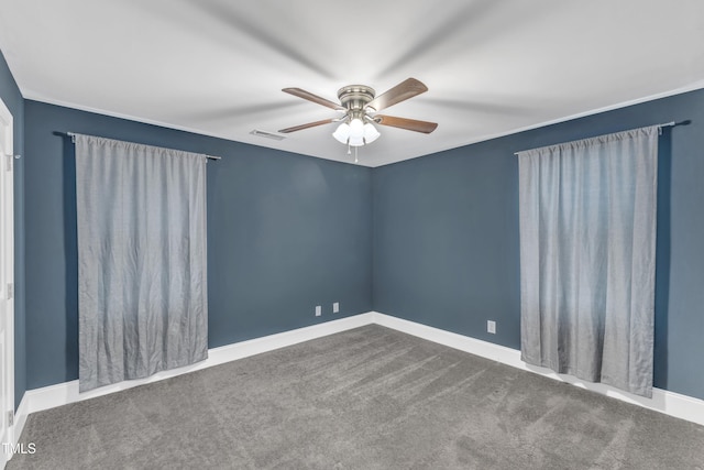 empty room featuring a ceiling fan, carpet, and baseboards