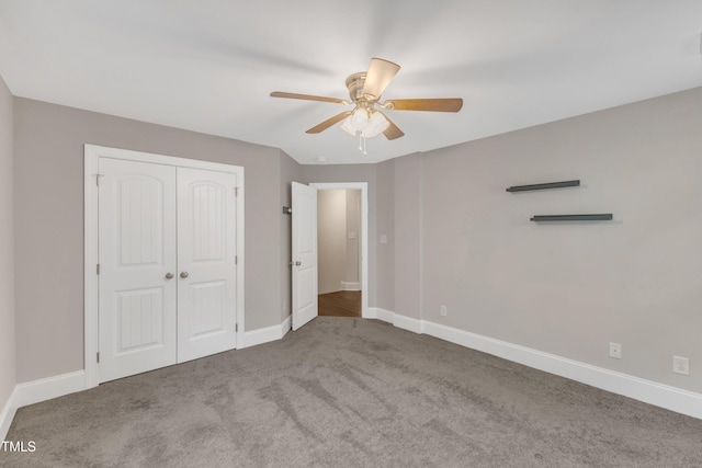 unfurnished bedroom featuring baseboards, carpet flooring, a closet, and a ceiling fan