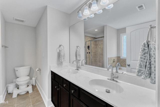 bathroom featuring tile patterned flooring, toilet, baseboards, a shower stall, and double vanity