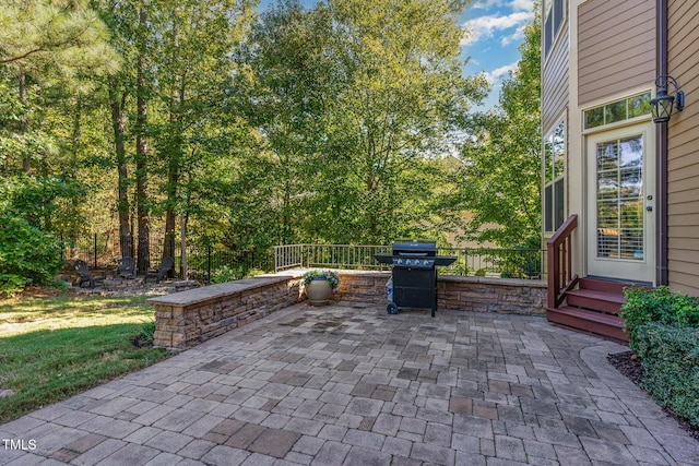 view of patio featuring area for grilling and fence