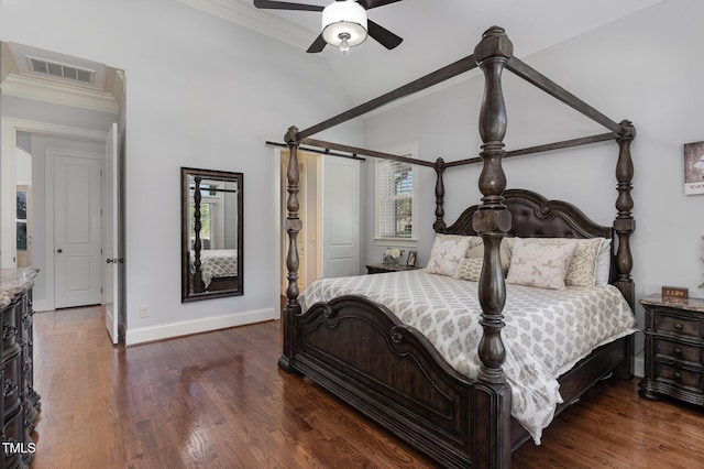 bedroom featuring multiple windows, baseboards, vaulted ceiling, crown molding, and dark wood-style flooring