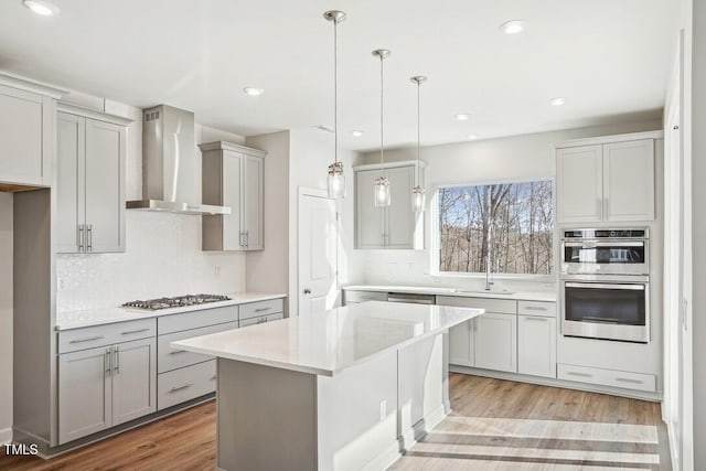 4611 Mint Leaf Ln, Raleigh, NC 27612 - kitchen with wall chimney range hood, light countertops, tasteful backsplash, appliances with stainless steel finishes, and recessed lighting