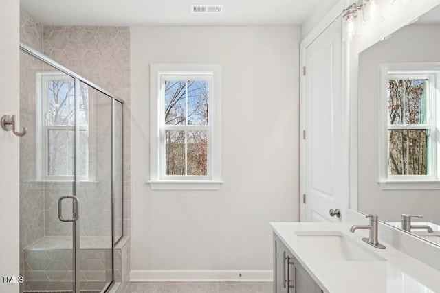 4611 Mint Leaf Ln, Raleigh, NC 27612 - bathroom featuring healthy amount of natural light, a stall shower, and vanity