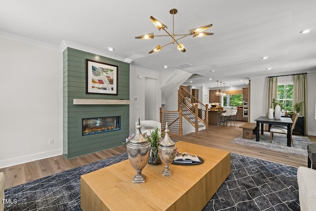 4611 Mint Leaf Ln, Raleigh, NC 27612 - living area with a chandelier, stairway, a fireplace, ornamental molding, and recessed lighting