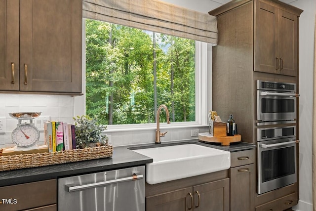 4611 Mint Leaf Ln, Raleigh, NC 27612 - kitchen with stainless steel appliances, backsplash, dark countertops, and healthy amount of natural light