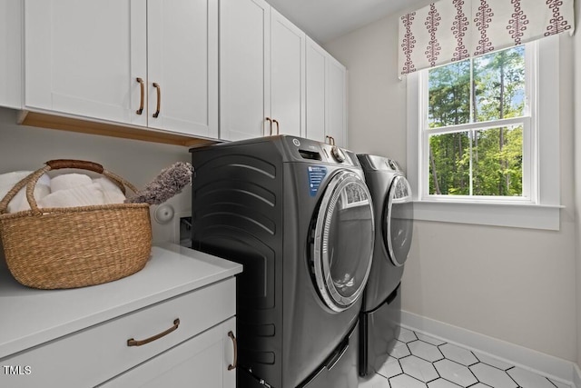 4611 Mint Leaf Ln, Raleigh, NC 27612 - laundry room with cabinet space, separate washer and dryer, plenty of natural light, and light tile patterned floors
