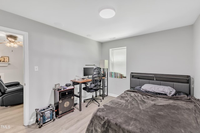 bedroom with wood finished floors, a desk, and baseboards