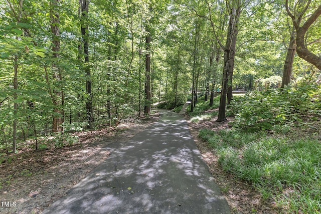view of road featuring a forest view