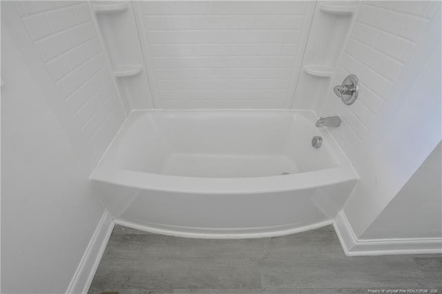 bathroom featuring wood finished floors and baseboards
