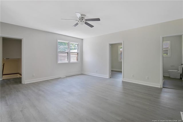 spare room featuring a ceiling fan, wood finished floors, and baseboards