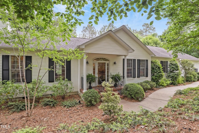 single story home with roof with shingles