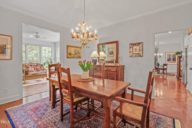 dining space with a chandelier, baseboards, crown molding, and ceiling fan