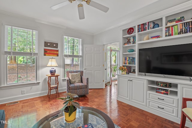 sitting room with ornamental molding, a ceiling fan, and baseboards