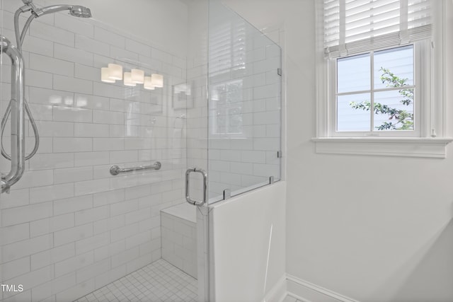 full bath with a shower stall and baseboards