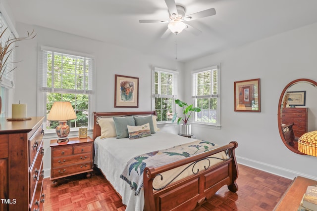 bedroom featuring baseboards and ceiling fan