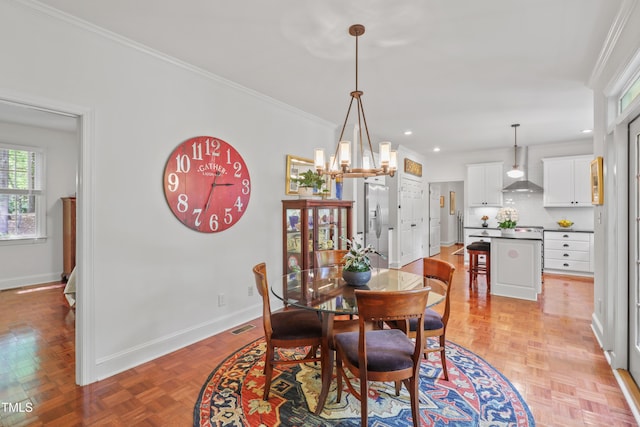 dining space with baseboards, ornamental molding, recessed lighting, and a chandelier