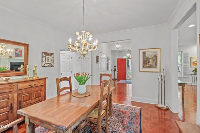 dining room featuring a chandelier, crown molding, and baseboards