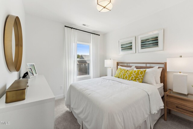 carpeted bedroom featuring baseboards