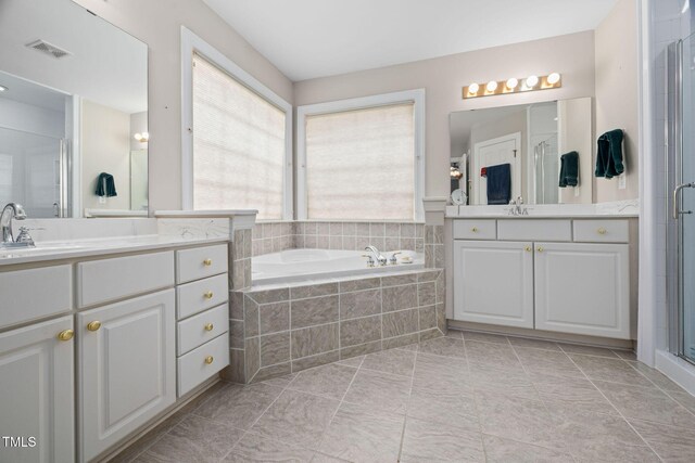 111 Gingergate Dr, Cary, NC 27519 - full bath with two vanities, a bath, a stall shower, and tile patterned floors