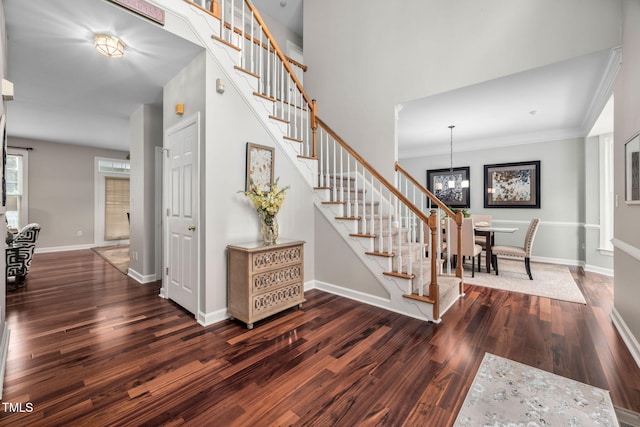 111 Gingergate Dr, Cary, NC 27519 - foyer entrance with stairs, wood finished floors, a chandelier, crown molding, and a high ceiling