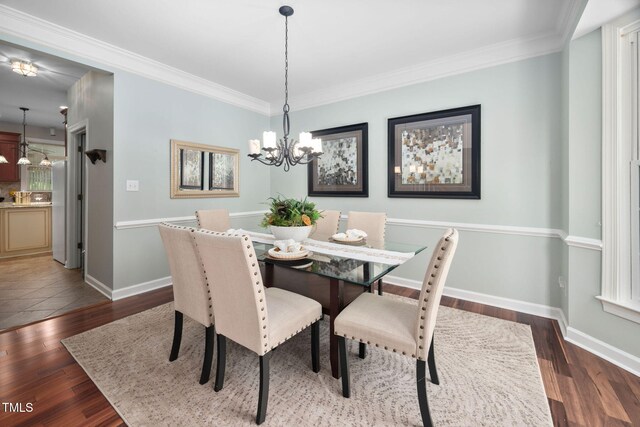 111 Gingergate Dr, Cary, NC 27519 - dining room featuring wood finished floors, ornamental molding, and a chandelier