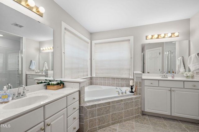 111 Gingergate Dr, Cary, NC 27519 - bathroom with two vanities, a garden tub, and a shower stall