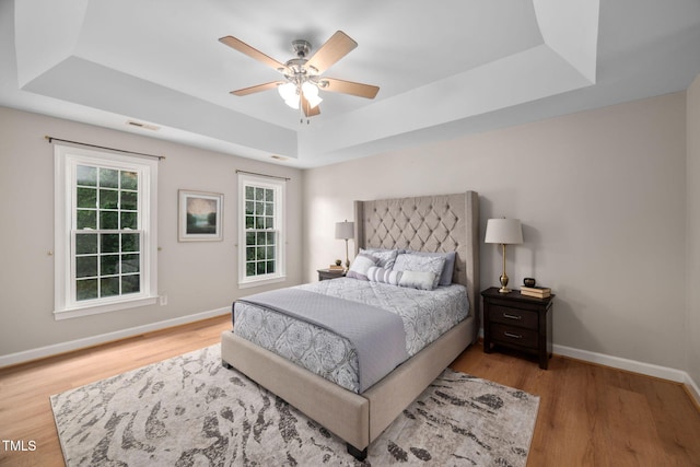111 Gingergate Dr, Cary, NC 27519 - bedroom featuring a raised ceiling, wood finished floors, and a ceiling fan