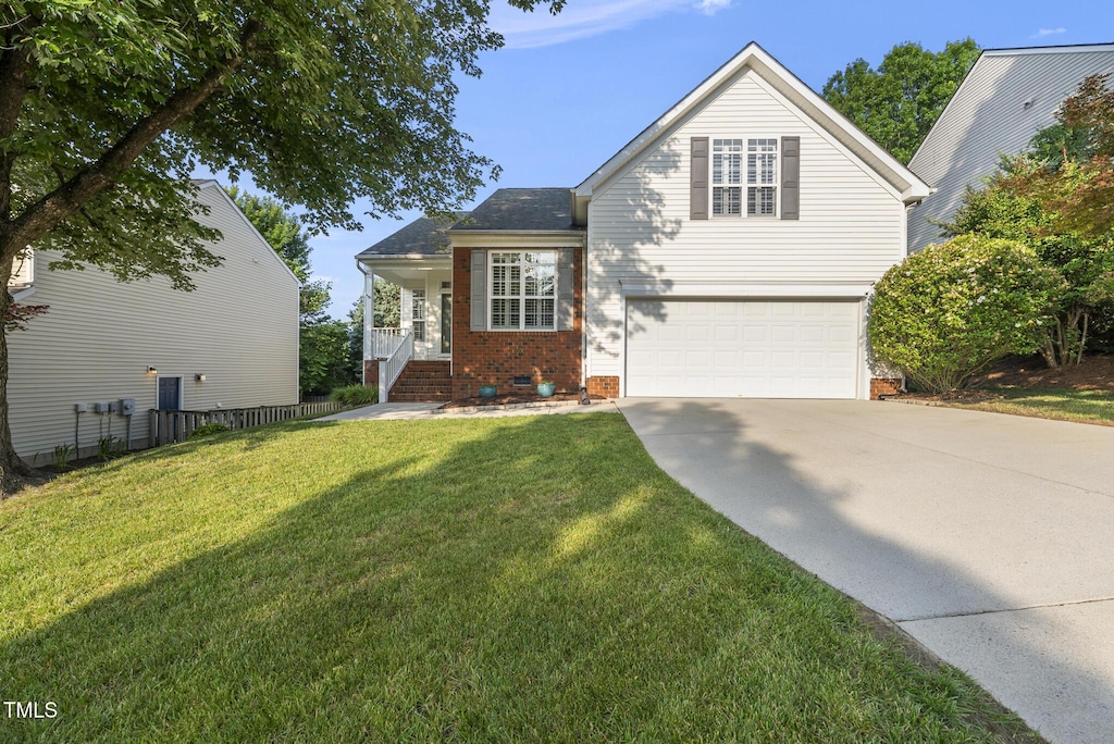 12505 Garden Tree Ln, Raleigh, NC 27614 - view of front of house featuring concrete driveway, an attached garage, a front yard, and brick siding