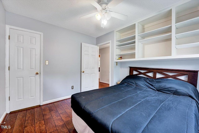 bedroom featuring wood-type flooring, baseboards, ceiling fan, and a textured ceiling