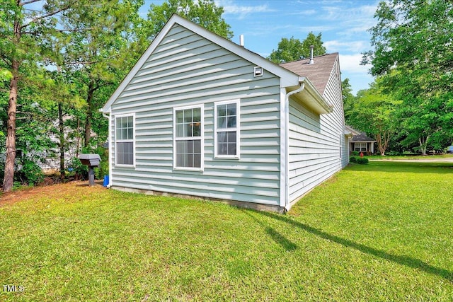 view of side of home with a lawn