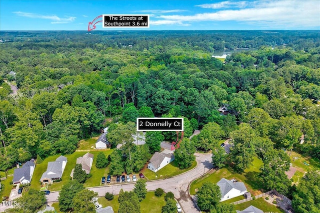 view of property location with a heavily wooded area