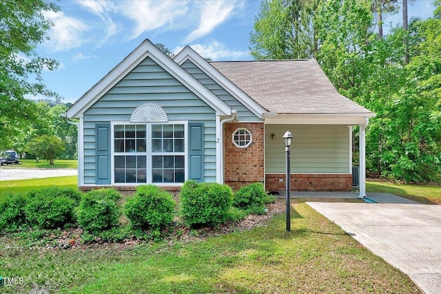 ranch-style home with brick siding, a front lawn, and concrete driveway